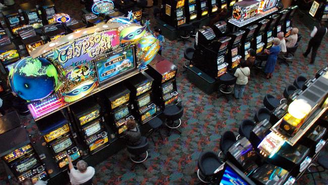 Punters play poker machines at Bankstown District Sports Club in Sydney.