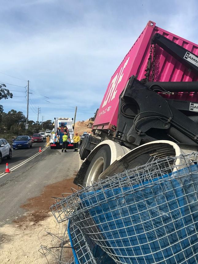 A prime mover towing a trailer carrying a shipping container, left Mona Vale Rd (East) at Ingleside at 6.50am and crashed over a concrete safety barrier in a road construction zone. Picture: Live Traffic NSW