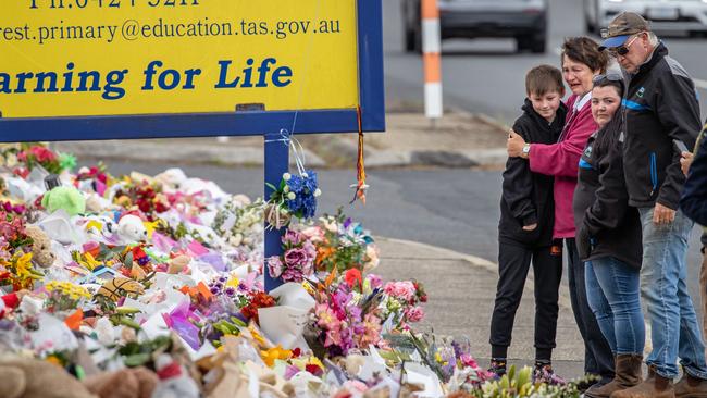 A child who whiteness the incident visit the scene with his family. Monday Pictures. Mourners pay tribute to the children who died after gust of wind swept away a jumping castle at Hillcrest Primary School Devonport Tasmania. Picture: Jason Edwards