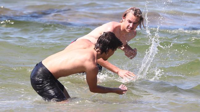 Schoolies enjoy the water at Clarkes Beach in Byron Bay. Photograph: Jason O'Brien
