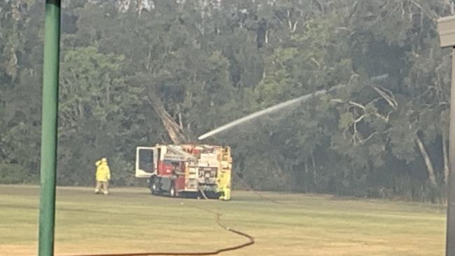 Firefighters tackling a blaze in bush near the Helensvale Aquatic Centre.