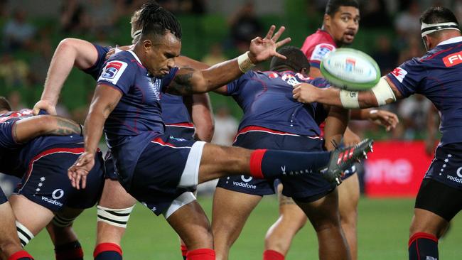 Rebels halfback Will Genia puts boot to ball against The Reds at AAMI Park on Friday. Picture: AAP