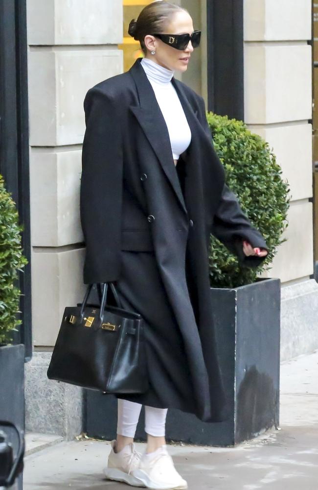 Circling back to Jennifer Lopez’s amazing week of looks, here she is making white leggings and a crop top look luxe by pairing them with a long black coat, Hermes Birkin bag and oversized Dior sunnies. Picture: BACKGRID Australia