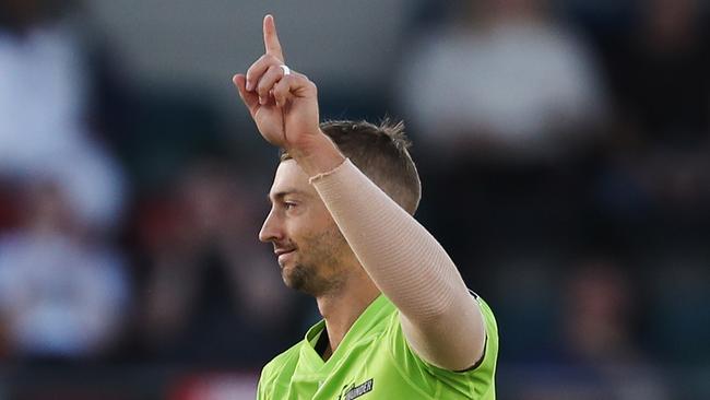 CANBERRA, AUSTRALIA - DECEMBER 14: Daniel Sams of the Thunder  celebrates after claiming the wicket of Sam Heazlett of the Heat during the Big Bash League match between the Sydney Thunder and the Brisbane Heat at Manuka Oval, on December 14, 2020, in Canberra, Australia. (Photo by Brendon Thorne/Getty Images)