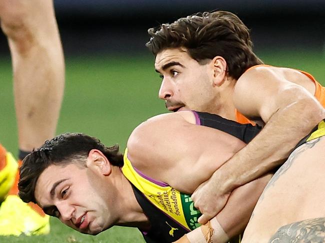 MELBOURNE, AUSTRALIA - JULY 14: Tim Taranto of the Tigers is tackled by Toby Bedford of the Giants during the 2024 AFL Round 18 match between the Richmond Tigers and the GWS GIANTS at Melbourne Cricket Ground on July 14, 2024 in Melbourne, Australia. (Photo by Michael Willson/AFL Photos via Getty Images)