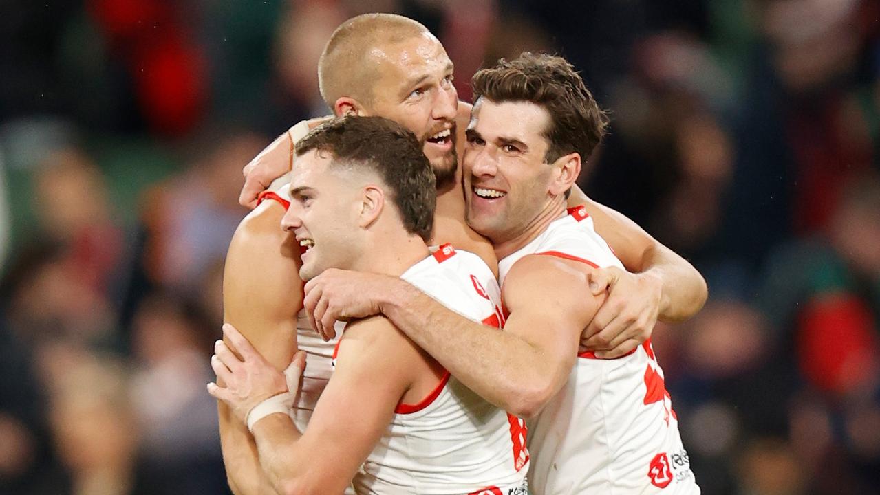 MELBOURNE, AUSTRALIA - JUNE 04: (L-R) Tom Papley, Sam Reid and Robbie Fox of the Swans celebrate during the 2022 AFL Round 12 match between the Melbourne Demons and the Sydney Swans at the Melbourne Cricket Ground on June 04, 2022 in Melbourne, Australia. (Photo by Michael Willson/AFL Photos via Getty Images)