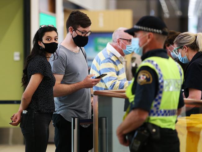 The first passengers on board qantas flight from Melbourne arrive at Hobart airport after the borders reopened to Victoria today. Picture: Zak Simmonds