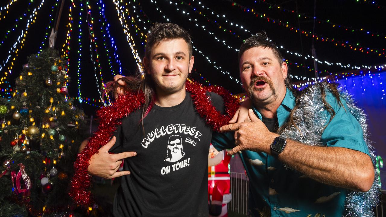 Alex (left) and Brett Paynter at their Warwick St Christmas lights display after being part of the winning family crew at Mulletfest. Picture: Kevin Farmer