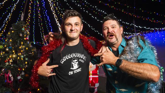 Alex (left) and Brett Paynter at their Warwick St Christmas lights display after being part of the winning family crew at Mulletfest. Picture: Kevin Farmer