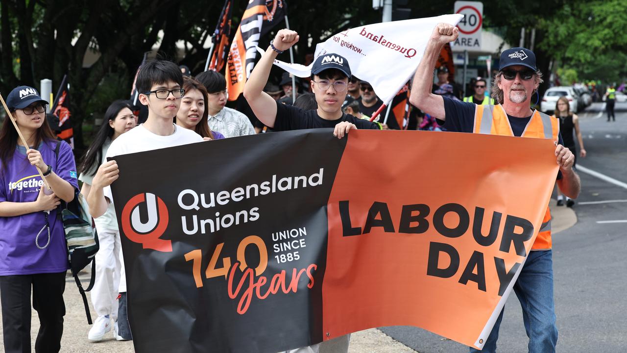 Thomas Chan, Ray Wong and Steve Blacklow lead the annual Labour Day march along Wharf Street towards the Cairns Esplanade. Picture: Brendan Radke