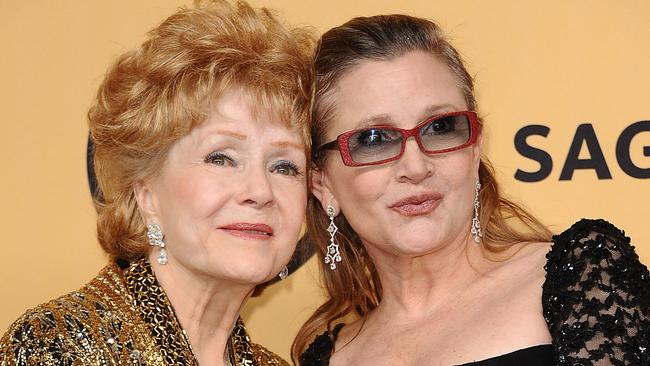 Debbie Reynolds and Carrie Fisher pose in the press room at the 21st annual Screen Actors Guild Awards. Picture: Jason LaVeris/FilmMagic