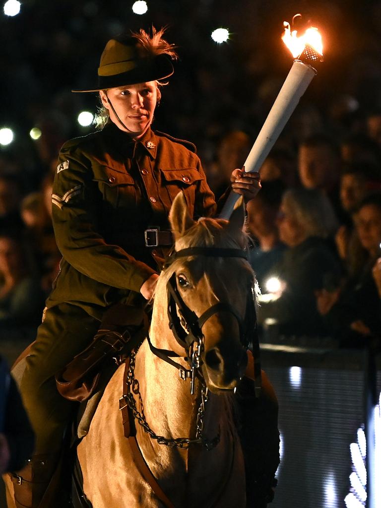 A torch is carried on horseback during Anzac observance ceremony. Picture: Quinn Rooney/Getty Images