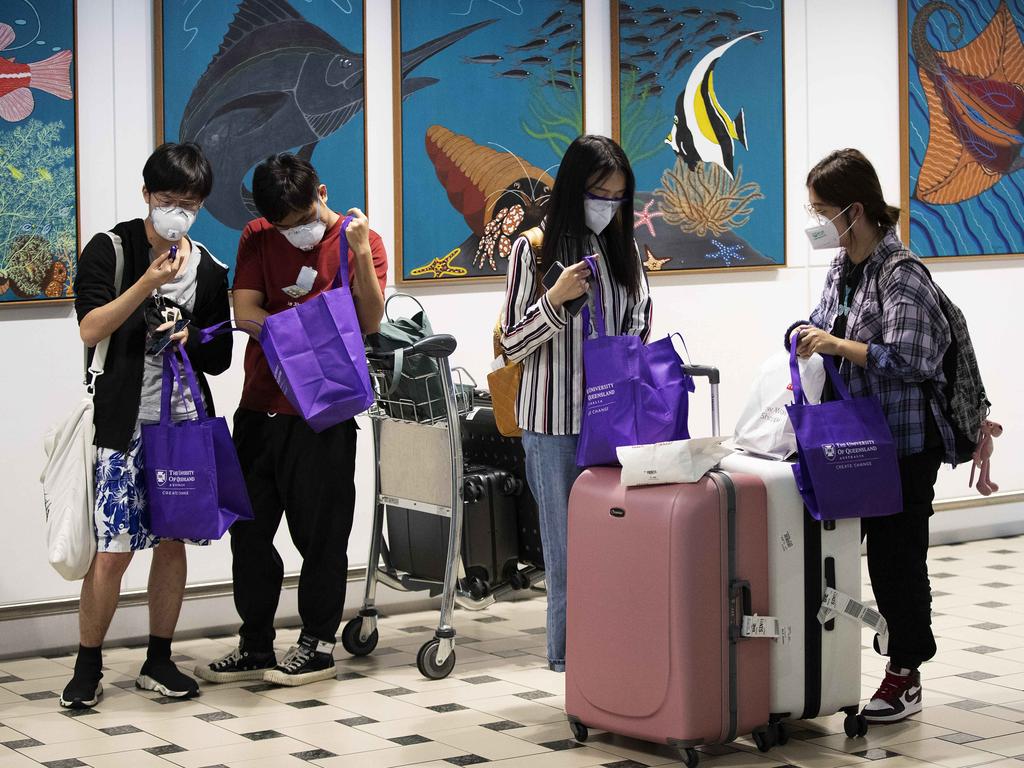 People wearing masks at the arrival lounge area at Brisbane International Airport. Picture: AAP