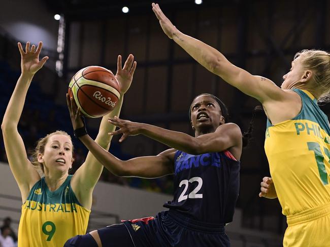 France's point guard Olivia Epoupa (C) jumps for a basket between Australia's forward Natalie Burton (L) and Australia's shooting guard Erin Phillips.