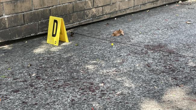 Blood stains on the footpath of the incident.