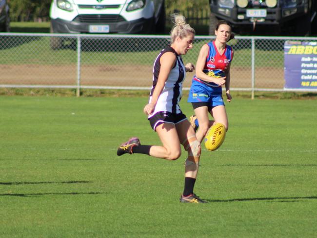 Claremont's Natalie Smedley gets a kick away during the match against Huonville in the SFLW Premiership League. Picture: Jake Garland