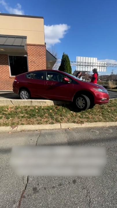 Strangers help rescue motorist stuck on drive-thru kerb