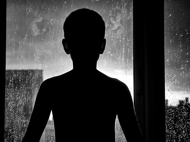 Silhouette of unrecognizable sad child. Generic iStock image.