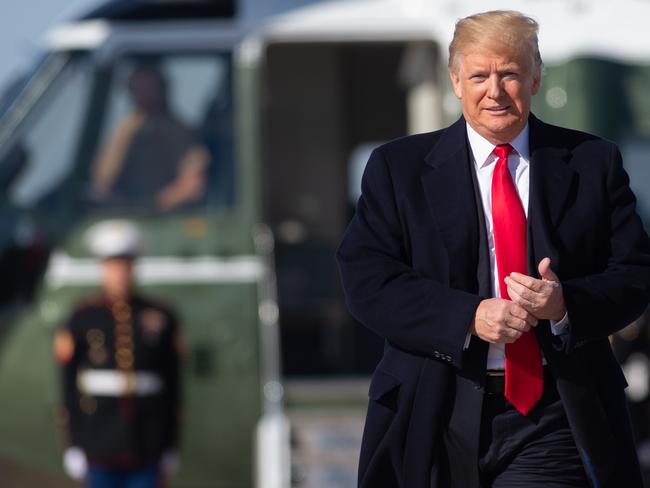 TOPSHOT - US President Donald Trump walks to Air Force One prior to departure from Joint Base Andrews in Maryland, October 22, 2018, as he travels to Houston, Texas to hold a campaign rally with US Senator Ted Cruz, Republican of Texas. (Photo by SAUL LOEB / AFP)