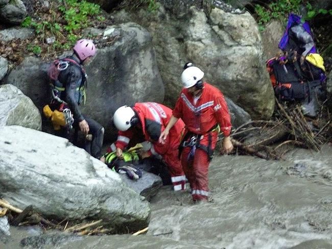 Rescue workers locate the body of a victim. Picture: AP