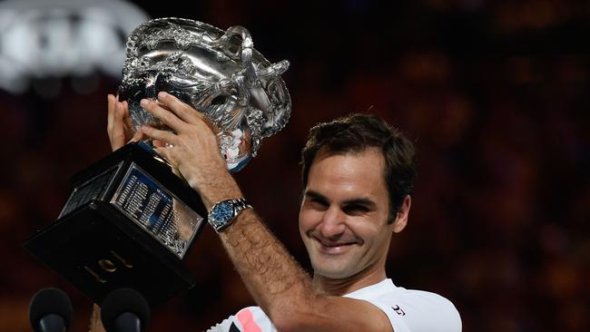 Switzerland's Roger Federer holds the winner's trophy after beating Croatia's Marin Cilic in their men's singles final match on day 14 of the Australian Open tennis tournament in Melbourne on January 28, 2018. / AFP PHOTO / SAEED KHAN / -- IMAGE RESTRICTED TO EDITORIAL USE - STRICTLY NO COMMERCIAL USE --