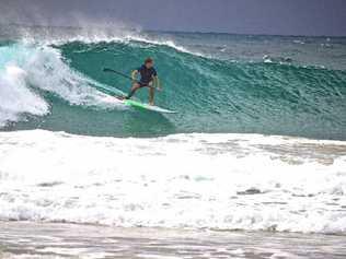 WHAT’S SUP?: Trevor Tunnington catches a wave on his stand up paddleboard. Picture: Di Tunnington