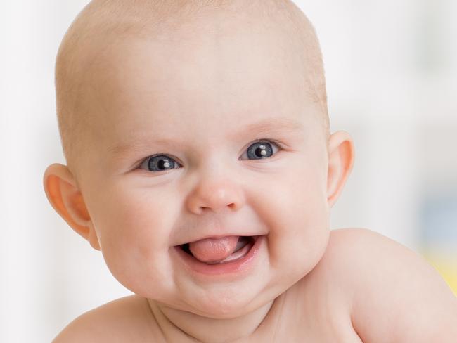 Cute smiling baby girl lying on towel