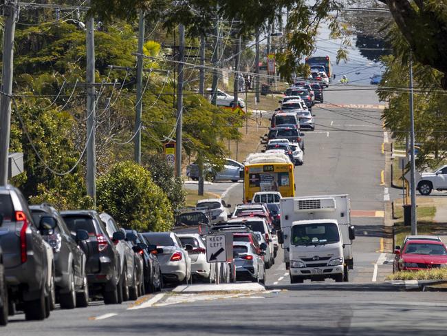 Cars queue outside St Thomas More College at Sunnybank on Friday. Picture: Sarah Marshall/NCA NewsWire