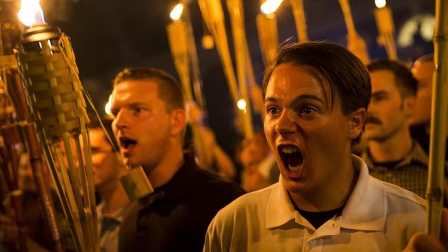 Spot the “fine person”. Neo Nazis and white supremacists chant as they walk through the streets of Charlottesville. (Pic: Samuel Corum/Getty)