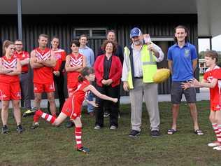 KICKING GOALS: Lismore's Deputy Mayor Elly Bird (centre) and Lismore Junior AFL Club players Neva Smith, 9, and Sydney-Jack Baker, 9 with Lismore City Council staff, and local AFL and cricket players, friends and supporters celebrate the opening of the new amenities block at Mortimer Oval. Picture: Alison Paterson