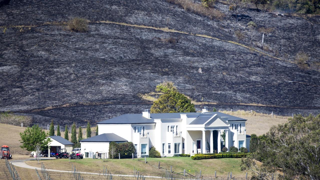 Flames burnt just metres from homes in the Sarabah region. Picture: Nigel Hallett