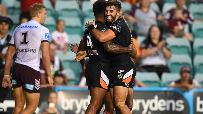 Kevin Naiqama of the Tigers is congratulated by James Tedesco after scoring a try during the round 2 NRL match between the Wests Tigers and the Manly-Warringah Sea Eagles at Leichhardt Oval in Sydney, Monday, March 14, 2016. (AAP Image/Dan Himbrechts) NO ARCHIVING, EDITORIAL USE ONLY