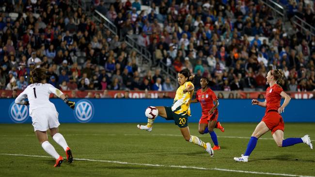 Matildas striker Sam Kerr splits open the US defence to get a shot on goal in Commerce City, Colorado. Picture: AFP