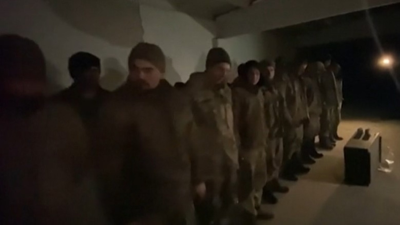 One clip showed soldiers lined up in a dark room.