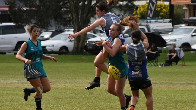 AFL North Coast. Tarryn Arnold's attempt to take possession is spoiled by a desperate Northern Beaches defence. Photo: Green Shoots Marketing