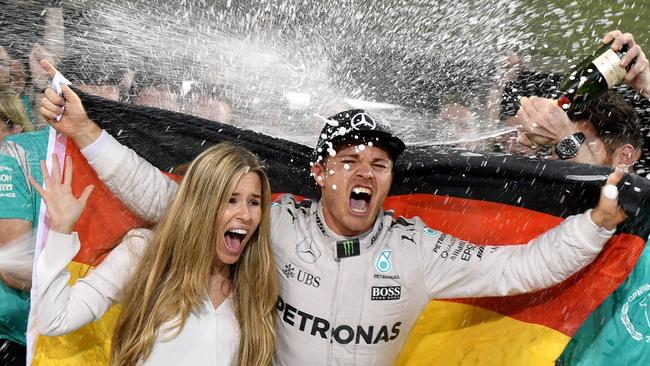 Nico Rosberg and his wife, Vivian, celebrate the world championship.