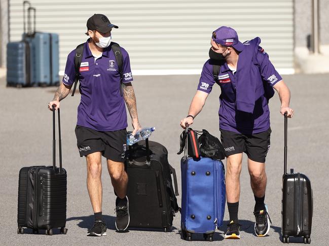 PERTH, AUSTRALIA - JUNE 29: Nathan Wilson and Luke Ryan of the Dockers walk to a waiting bus at Cockburn ARC in preparation to make the trip to Melbourne ahead of round 16 of the AFL season, on June 29, 2021 in Perth, Australia. (Photo by Paul Kane/Getty Images)