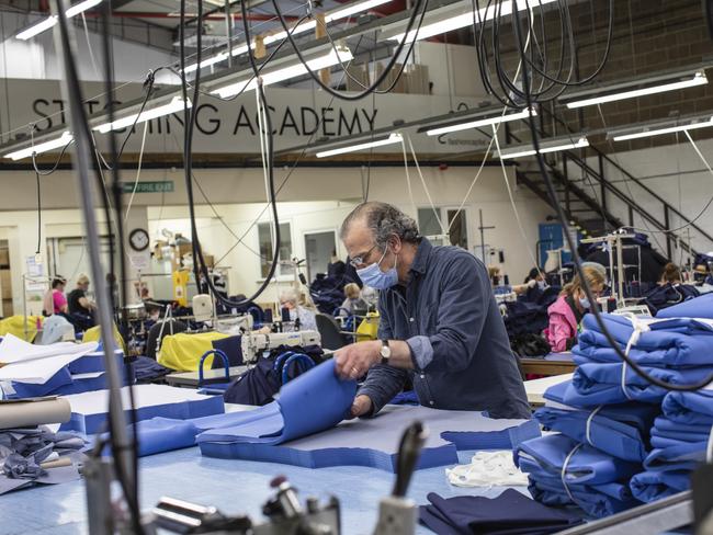 LONDON, ENGLAND - APRIL 24: Employees at 'Fashion Enter' make scrubs for NHS staff on April 24, 2020 in London, England.The British government has extended the lockdown restrictions first introduced on March 23 that are meant to slow the spread of COVID-19.  (Photo by Dan Kitwood/Getty Images)