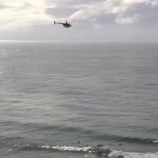 Helicopters have helped to keep surfers and swimmers safe from sharks.