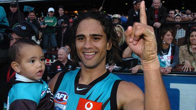 Jase Burgoyne with his dad after Port Adelaide’s 2004 premiership win. Picture: AAP/Stuart McEvoy