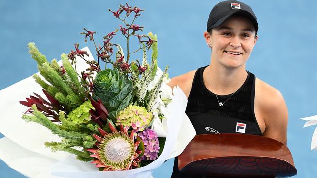 Ashleigh Barty holds the women’s singles champion trophy after at Memorial Drive victory.