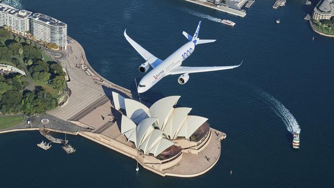 SYDNEY, AUSTRALIA - MAY 02: An Airbus A350-1000 flight test aircraft flies over Sydney Harbour to mark a major fleet announcement by Australian airline Qantas on May 02, 2022 in Sydney, Australia. Twelve Airbus A350-1000's will be ordered to operate non-stop "Project Sunrise" flights from Australia's east coast to New York, London and other key destinations. The aircraft will feature market-leading passenger comfort in each travel class with services to start by the end of 2025. (Photo by James D. Morgan/Getty Images for Airbus/Qantas) *** BESTPIX ***