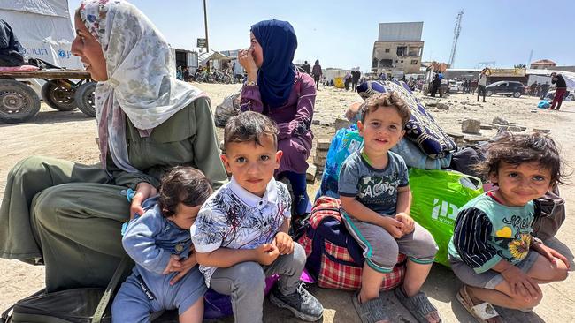 Palestinians sit with their belongings following an Israeli evacuation order. Picture: AFP