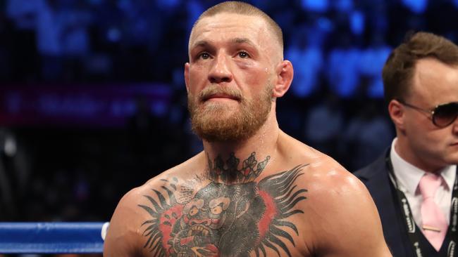 Conor McGregor stands in the ring after being defeated by Floyd Mayweather Jr.