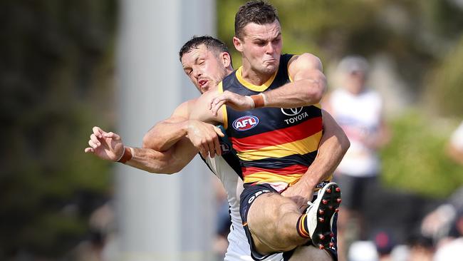 Adelaide’s Brad Crouch under pressure from Port’s Travis Boak. Picture: Sarah Reed