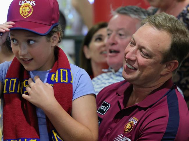 Queensland Premier Steven Miles shares a moment with his daughter Bridie Miles, 10, as they watch the 2024 AFL grand final match between the Brisbane Lions and the Sydney Swans at Cazalys Sports Club, Cairns. Picture: Brendan Radke