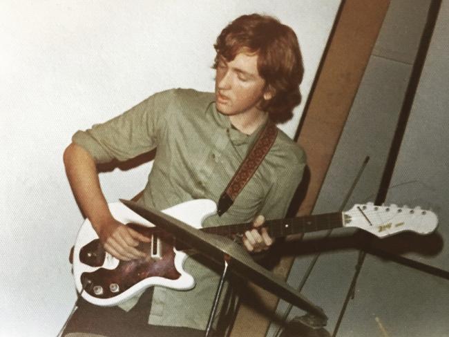 Jim Moginie performing with his band FARM’s first gig, at Sydney Grammar School in 1973 — he’s playing a $20 guitar through a Strauss Polka amp, and “there were 20 or 30 disinterested schoolkids in the audience”. Picture: Supplied