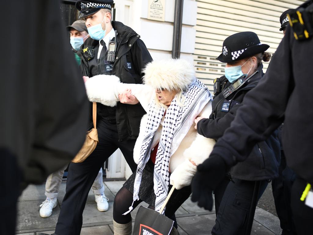 Police wrestle with a demonstrator outside Assange’s bail hearing. Picture: Getty