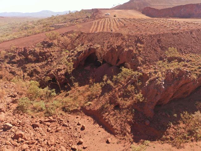 This handout photo taken on May 15, 2020 and released by the PKKP Aboriginal Corporation and recieved by AFP on May 27, 2020 shows Juukan Gorge in Western Australia -- one of the earliest known sites occupied by Aboriginals in Australia. - Anglo-Australian mining giant Rio Tinto has admitted damaging ancient Aboriginal rock shelters in the remote Pilbara region -- blasting near the 46,000-year-old heritage site to expand an iron ore mine. (Photo by Handout / PKKP Aboriginal Corporation / AFP)