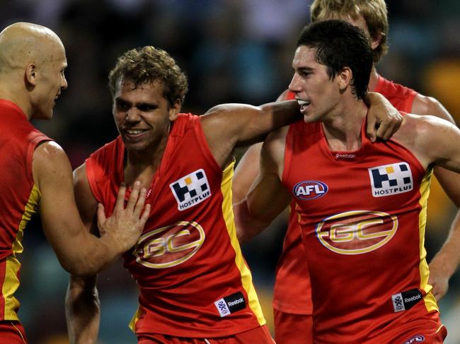 QClash one between Gold Coast Suns and Brisbane Lions from the Gabba. Gary Ablett (left), Nathan Krakouer and Michael Rischitelli.